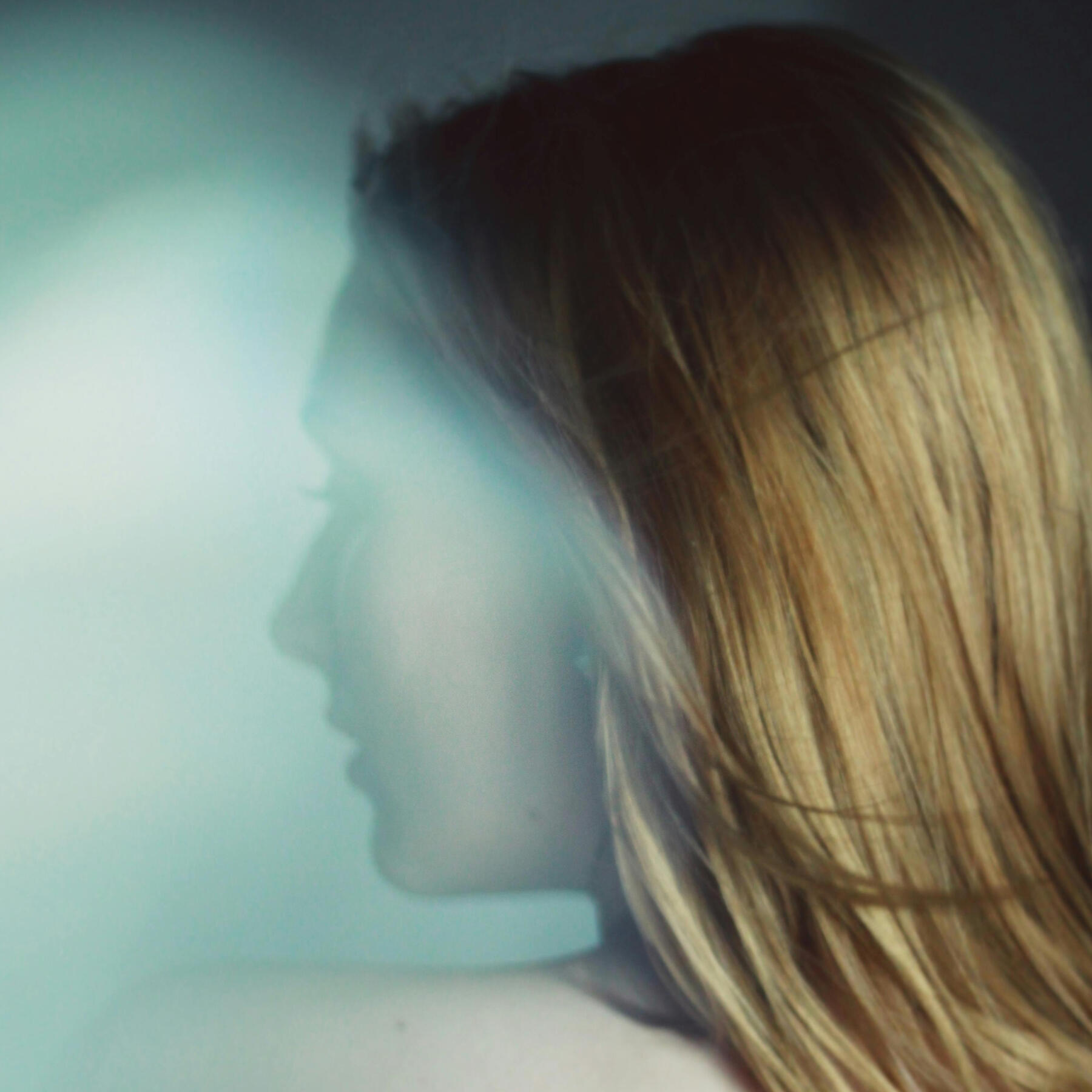 An image of a young woman with her head turned to the left.